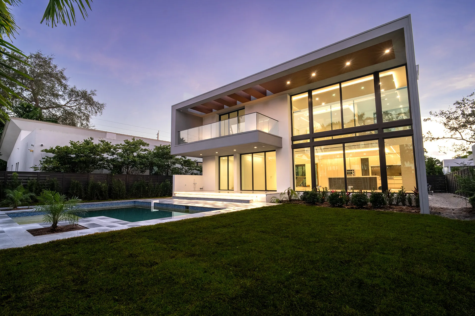 Rear elevation at dusk with pool